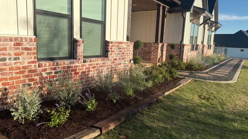 Narrow foundation bed with new plantings and steel edging — Landscape Design & Maintenance