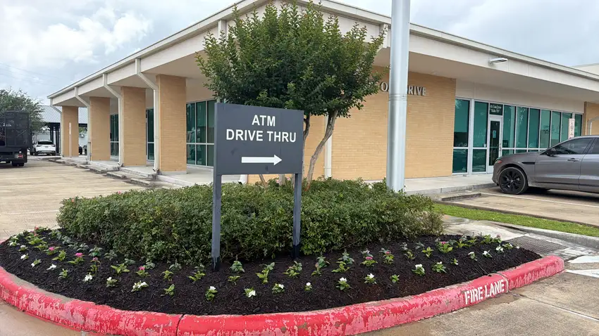 Bank drive-thru island planted with seasonal color — HOA & Commercial Properties