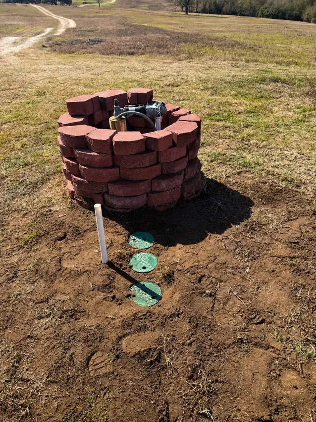 Sprinkler head and valve box set in a brick planter ring — Irrigation Projects